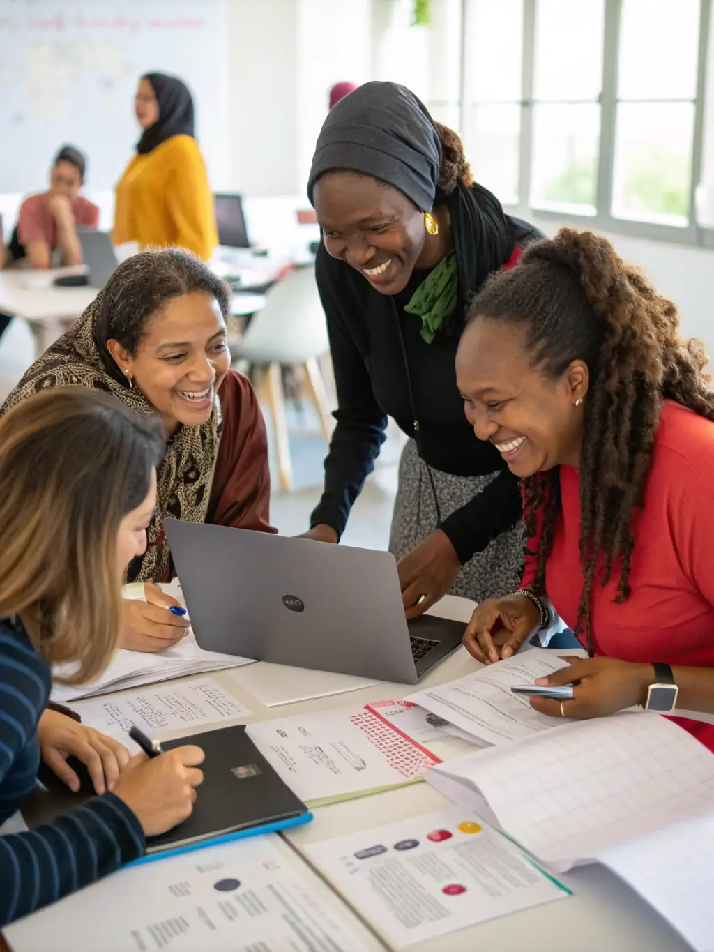 A diverse group of women participating in a F.E.M Project workshop, actively engaged in a hands-on activity, with smiles and expressions of collaboration and learning.